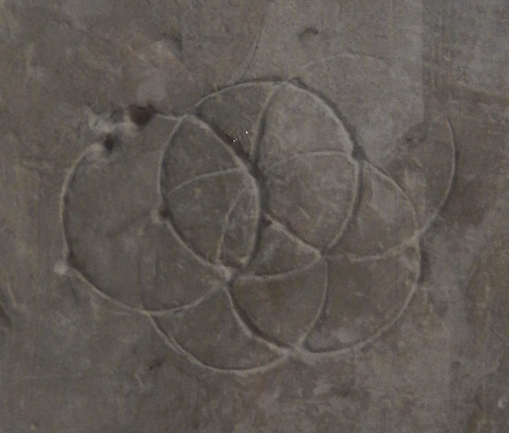 Image of interlocking circles carved into stone.